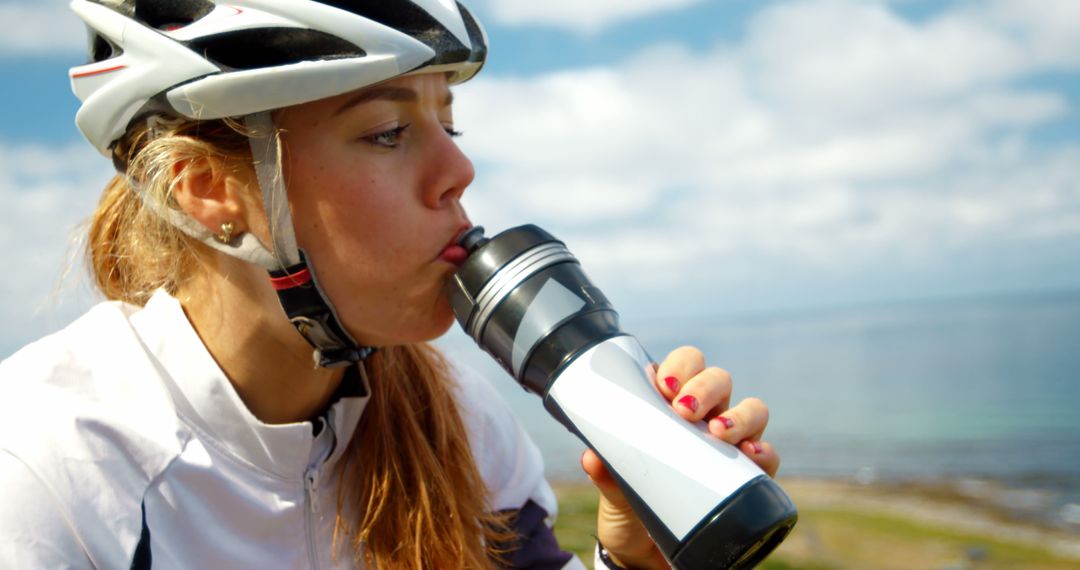 Female Cyclist Drinking Water During Outdoor Ride - Free Images, Stock Photos and Pictures on Pikwizard.com