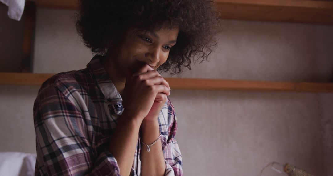 Smiling Woman with Afro Hair Enjoying Digital Interaction Indoors