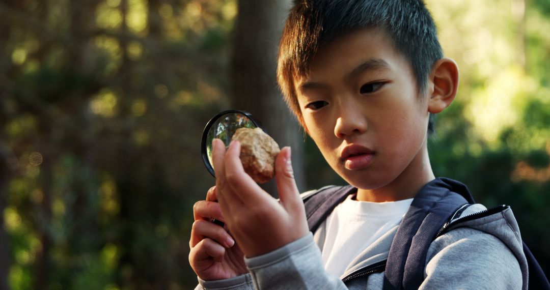 Curious Young Boy Exploring Nature with Magnifying Glass - Free Images, Stock Photos and Pictures on Pikwizard.com