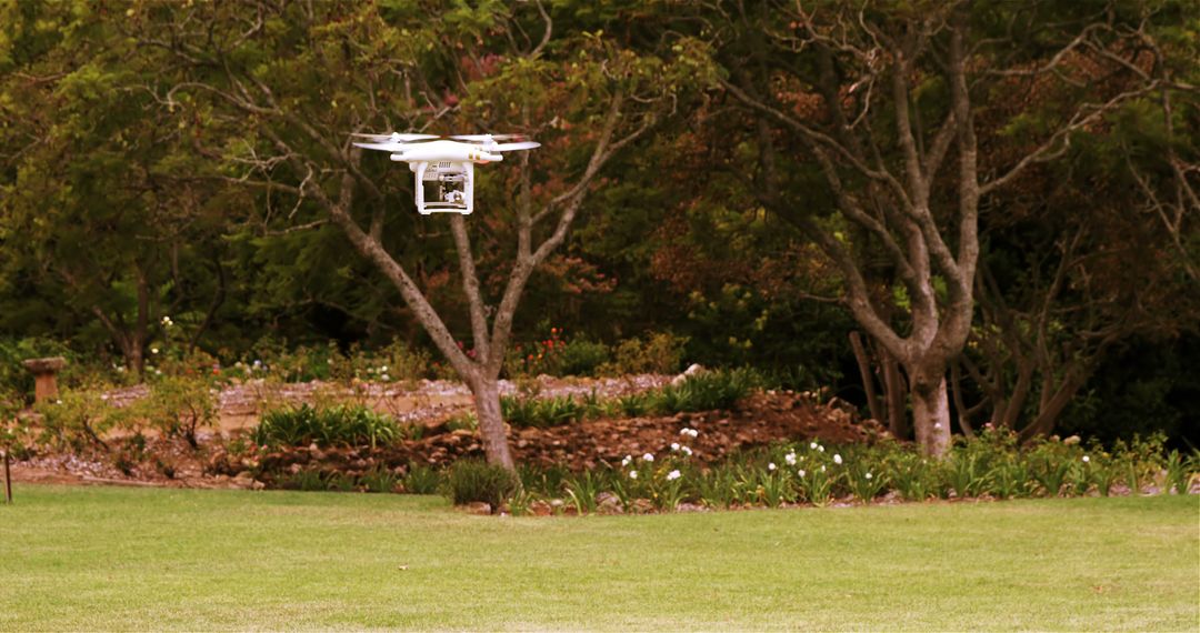 Garden Drone Hovering in Lush Green Park - Free Images, Stock Photos and Pictures on Pikwizard.com