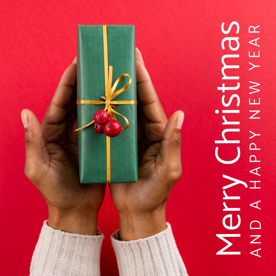 Hands Holding Christmas Gift with Greeting Text on Red Background