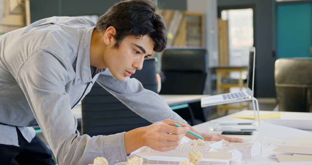 Young Male Architect Working on Building Model in Office - Free Images, Stock Photos and Pictures on Pikwizard.com