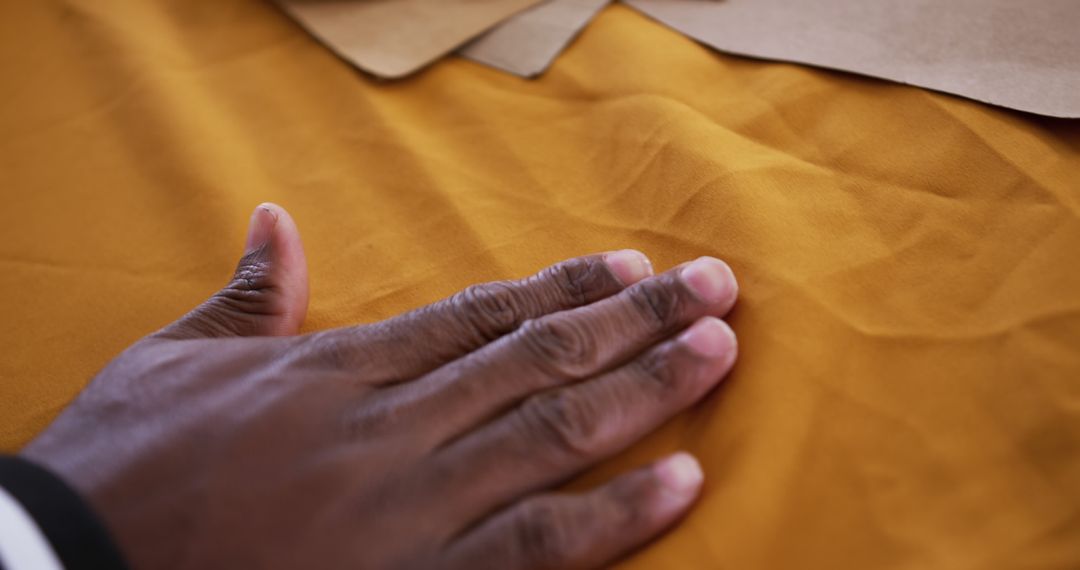 Close-Up of Hand Touching Yellow Fabric in Tailoring Workshop - Free Images, Stock Photos and Pictures on Pikwizard.com