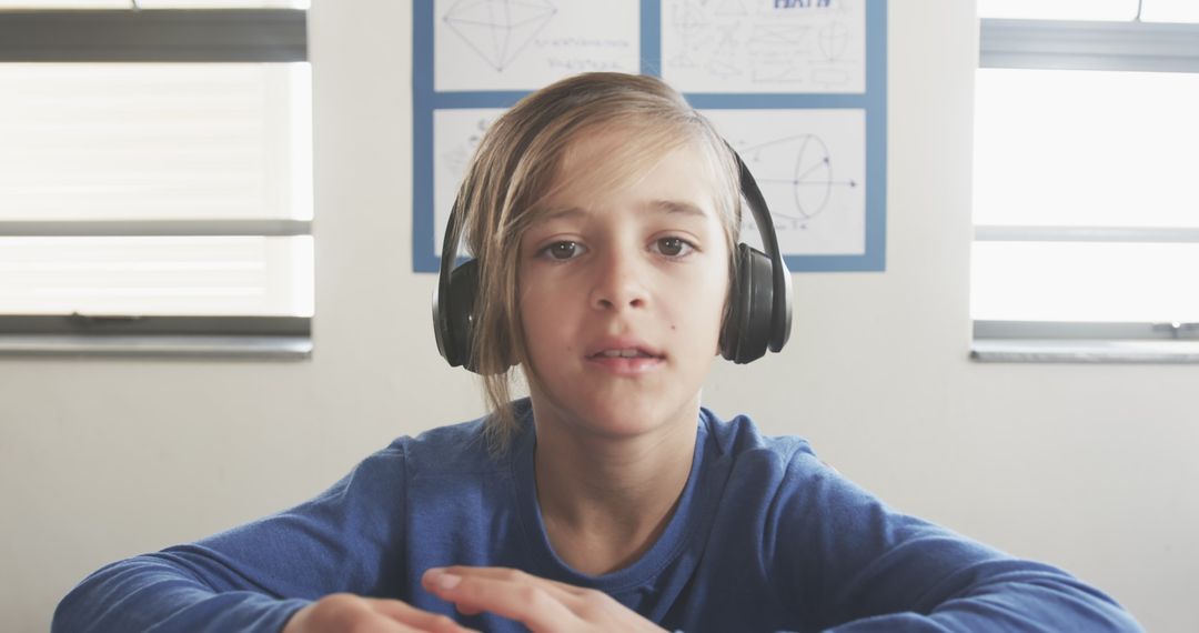 Schoolboy Focused with Headset in Study Space