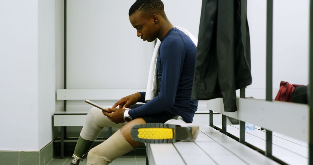 Athlete Using Tablet While Resting in Locker Room - Free Images, Stock Photos and Pictures on Pikwizard.com