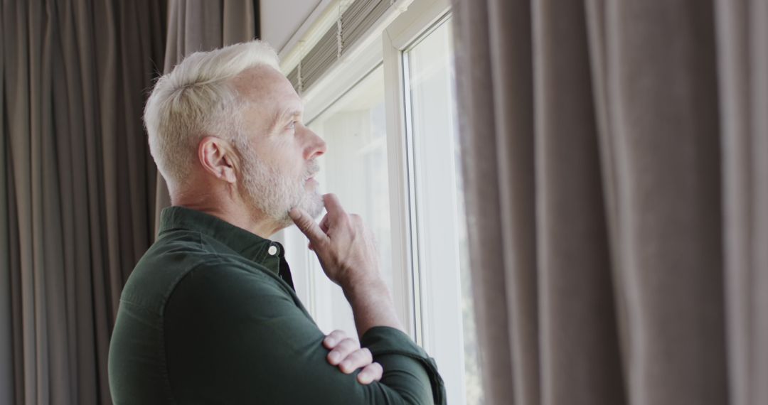 Thoughtful Middle Aged Man Looking Out Window Alone - Free Images, Stock Photos and Pictures on Pikwizard.com