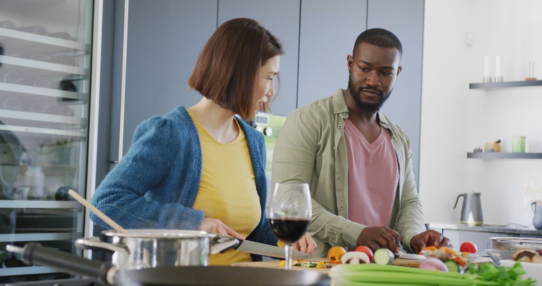 Image of diverse couple preparing food together in kitchen at home - Free Images, Stock Photos and Pictures on Pikwizard.com