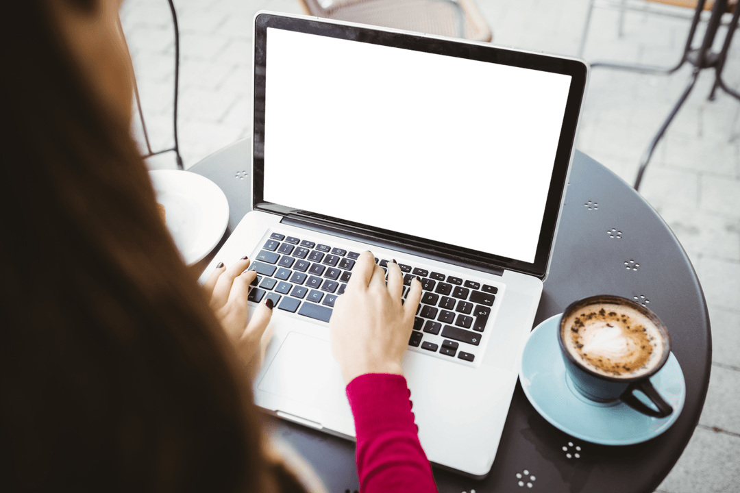 Businesswoman Typing on Transparent Laptop at Cafe Table