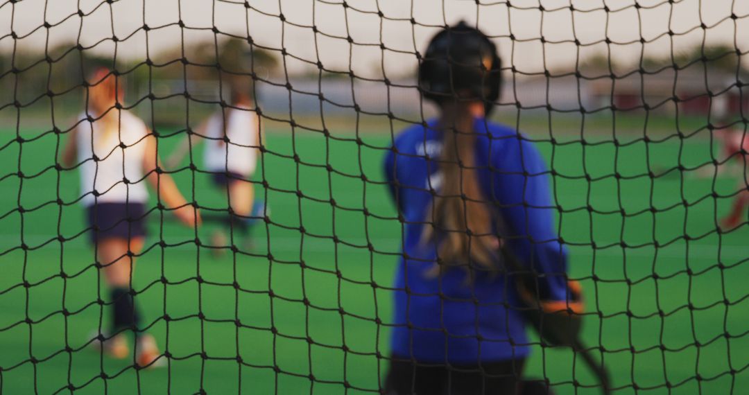 Youth Field Hockey Match Through Goal Netting - Free Images, Stock Photos and Pictures on Pikwizard.com