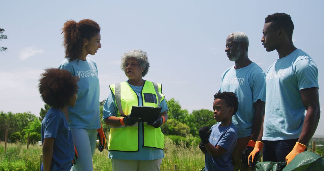 Volunteers of All Ages Discuss Community Cleanup Efforts Outdoors - Free Images, Stock Photos and Pictures on Pikwizard.com