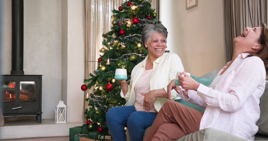 Joyful Mother and Daughter Chatting by Christmas Tree at Home