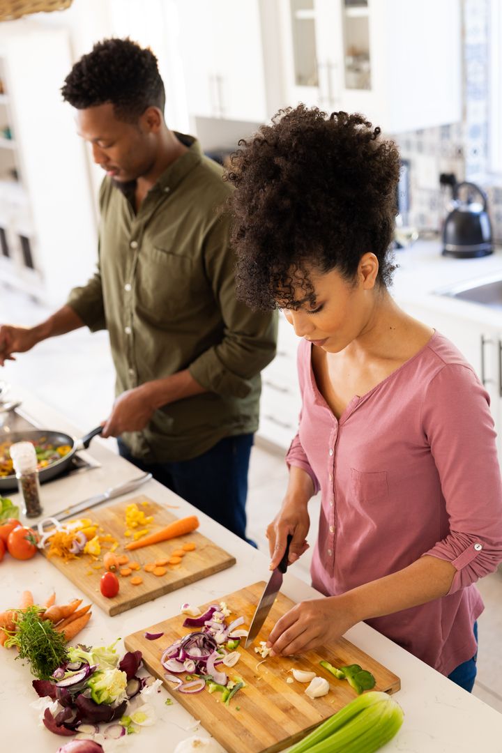 Happy Biracial Couple Preparing Food Together in Kitchen - Free Images, Stock Photos and Pictures on Pikwizard.com