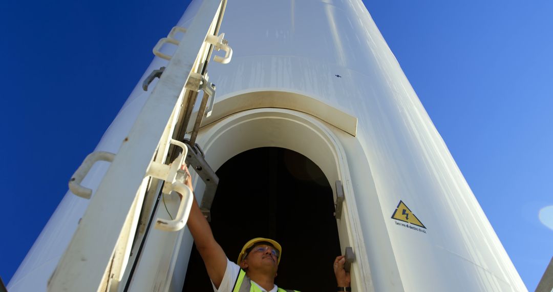 Engineer Inspecting Wind Turbine on Wind Farm - Free Images, Stock Photos and Pictures on Pikwizard.com