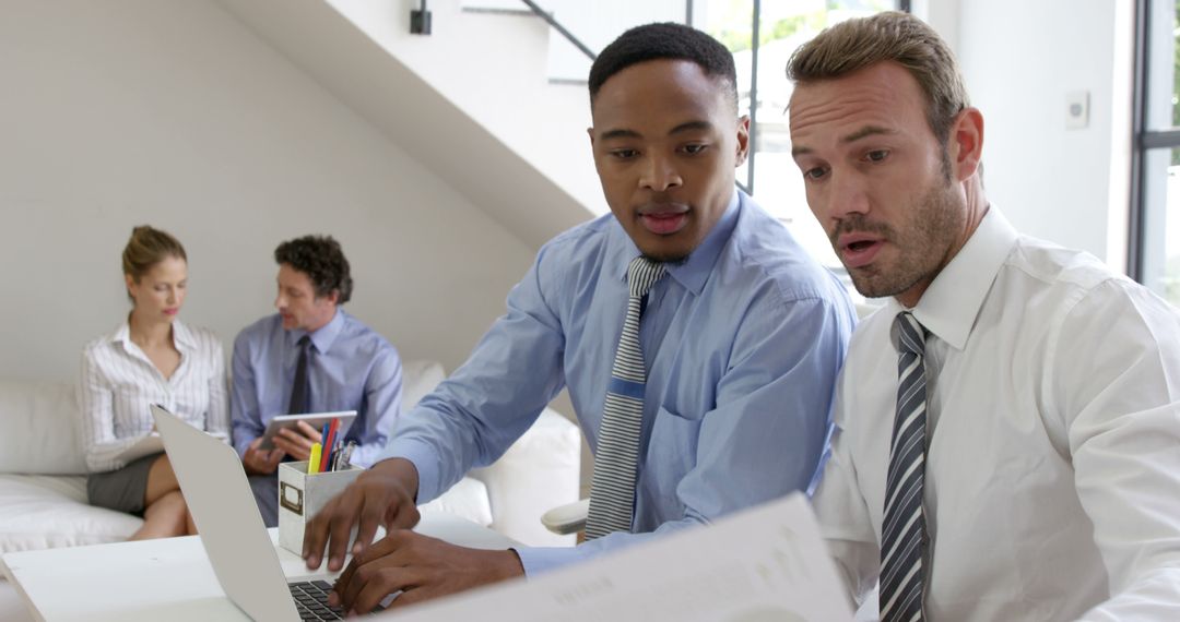 Collaborative Multiracial Business Team Working on Laptop in Modern Office