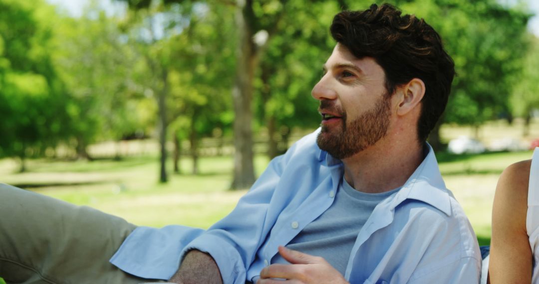 Smiling Man Relaxing Outdoors in Nature - Free Images, Stock Photos and Pictures on Pikwizard.com