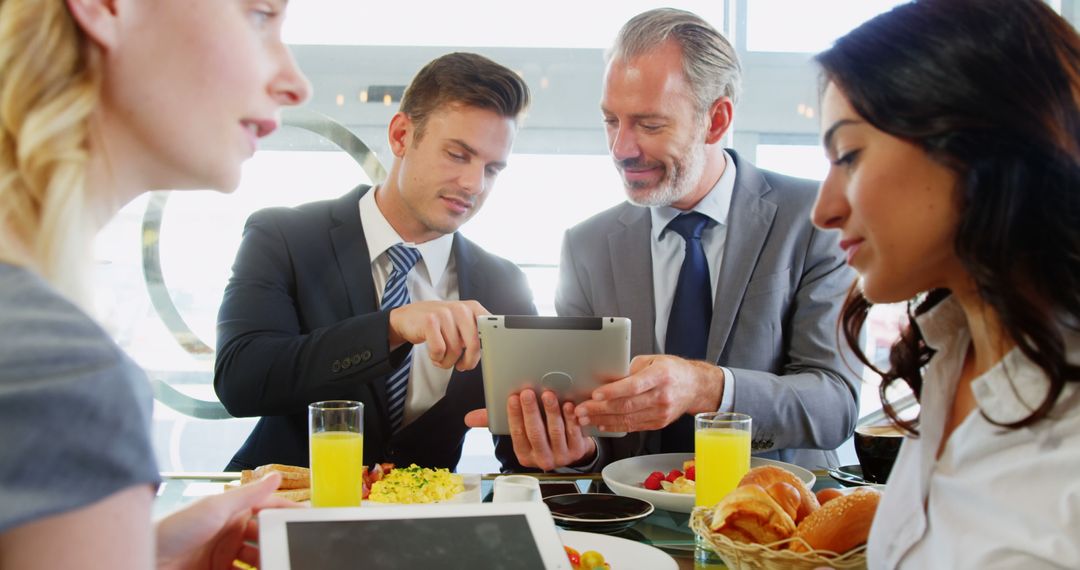 Business Meeting in Restaurant with Digital Tablets