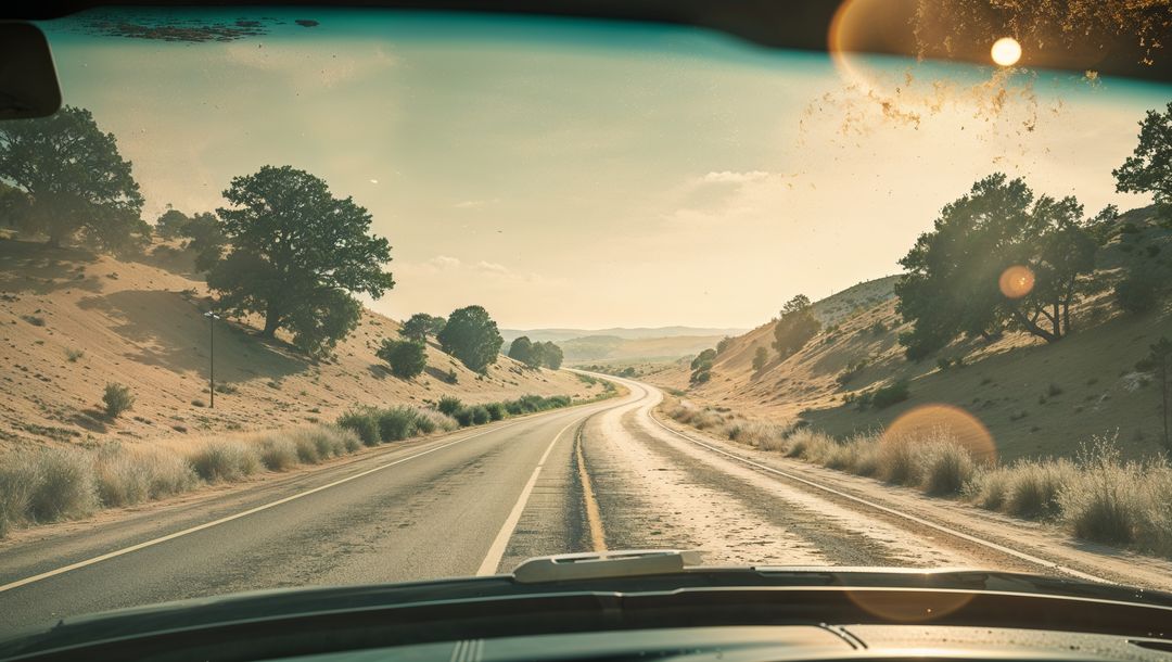 Winding Highway Through Desert Hills with Lens Flare