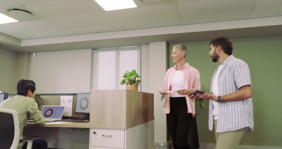 Coworkers Collaborating in Modern Office with Technology