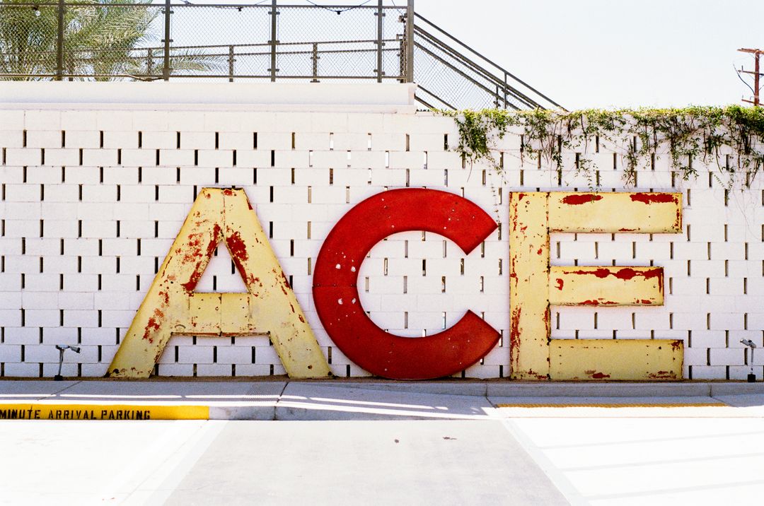 Large Retro 'ACE' Sign Against White Brick Wall - Free Images, Stock Photos and Pictures on Pikwizard.com