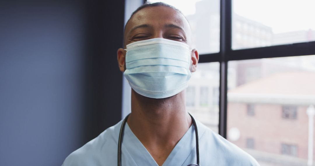 Confident Male Healthcare Worker Wearing Medical Face Mask Indoors - Free Images, Stock Photos and Pictures on Pikwizard.com