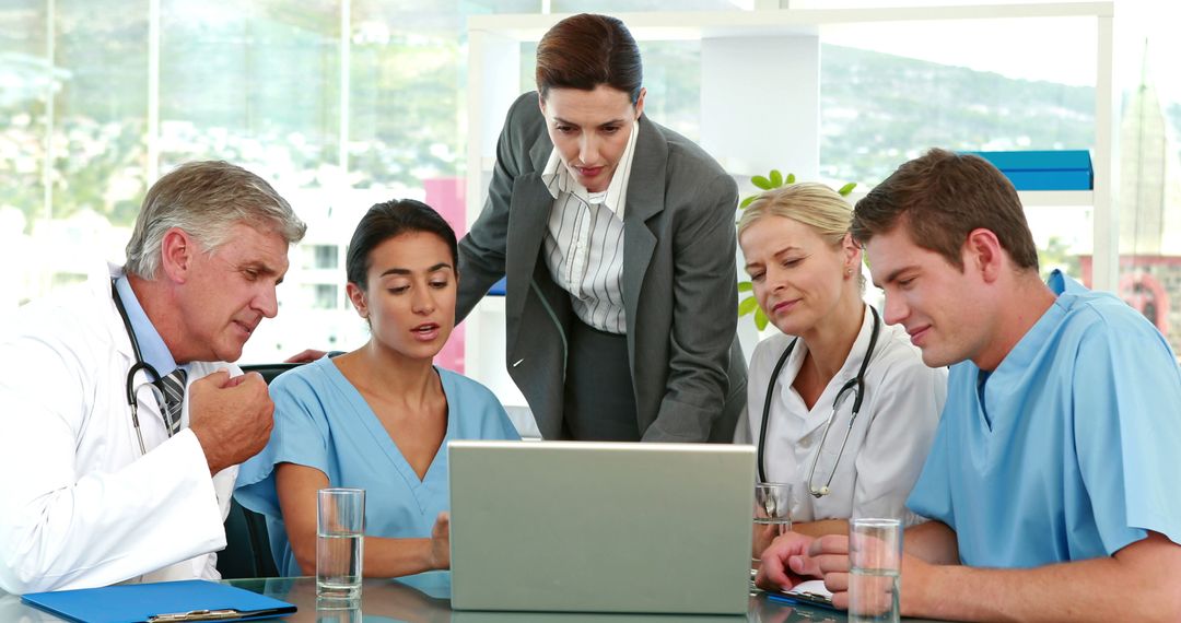 Healthcare Team Collaborating During Meeting with Laptop Assistance - Free Images, Stock Photos and Pictures on Pikwizard.com