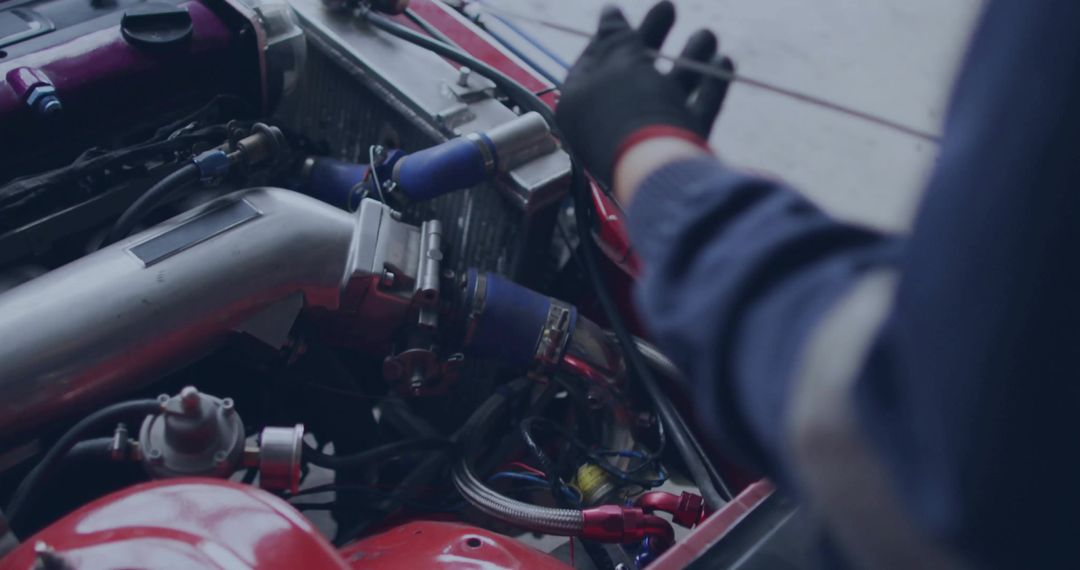 Mechanic Inspecting Car Engine's Aluminum Intake Pipe in Workshop