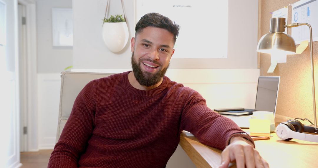 Man Smiling in Modern Home Office Working on Laptop