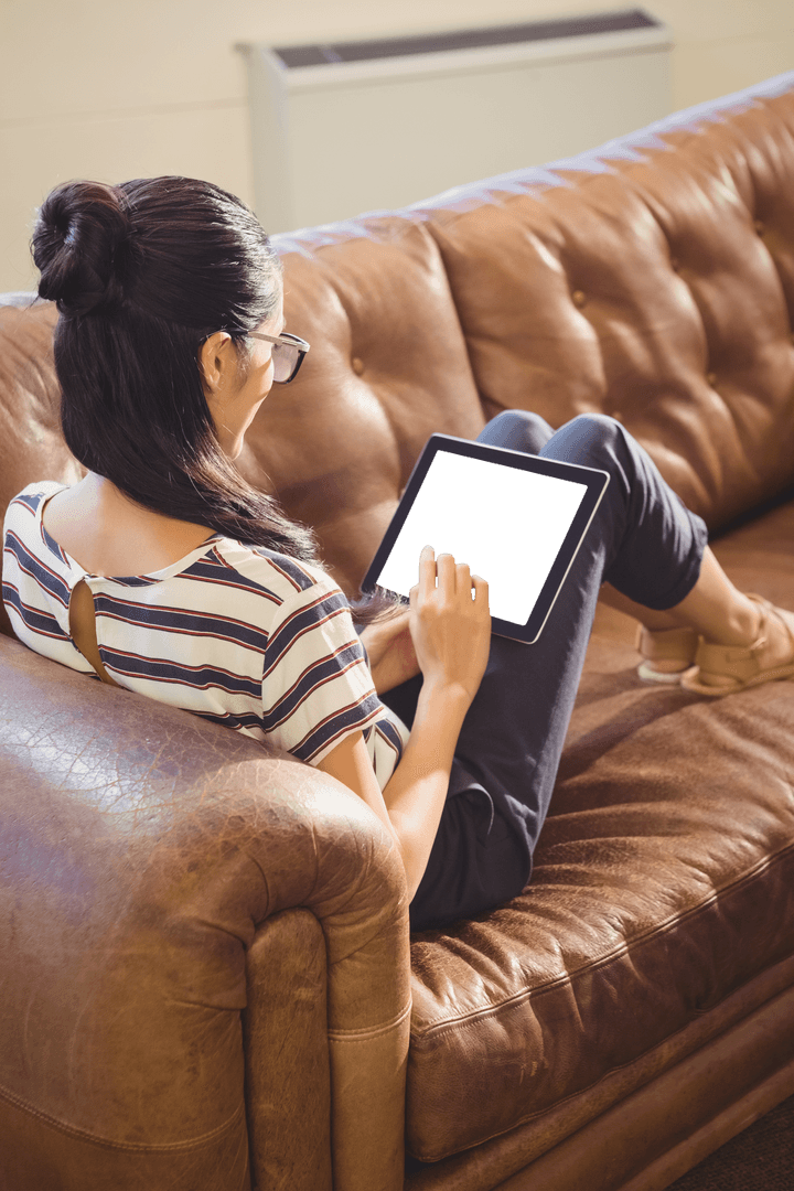 Businesswoman Relaxing on Sofa with Tablet Transparent Screen