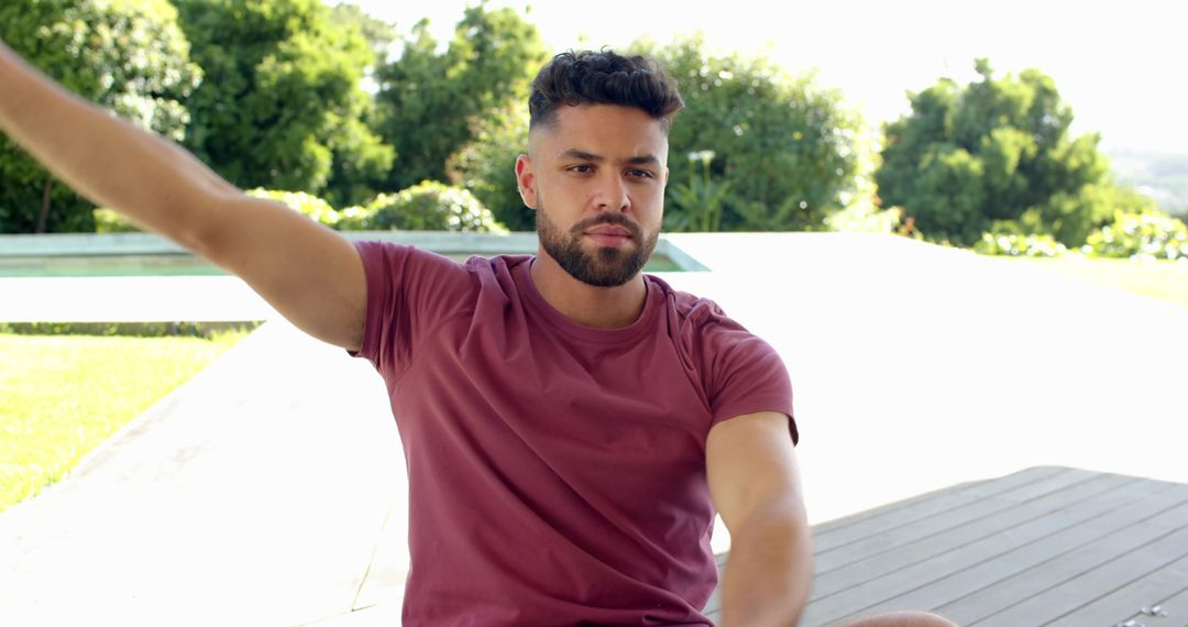 Man Relaxing Outdoors on Modern Deck with Nature View