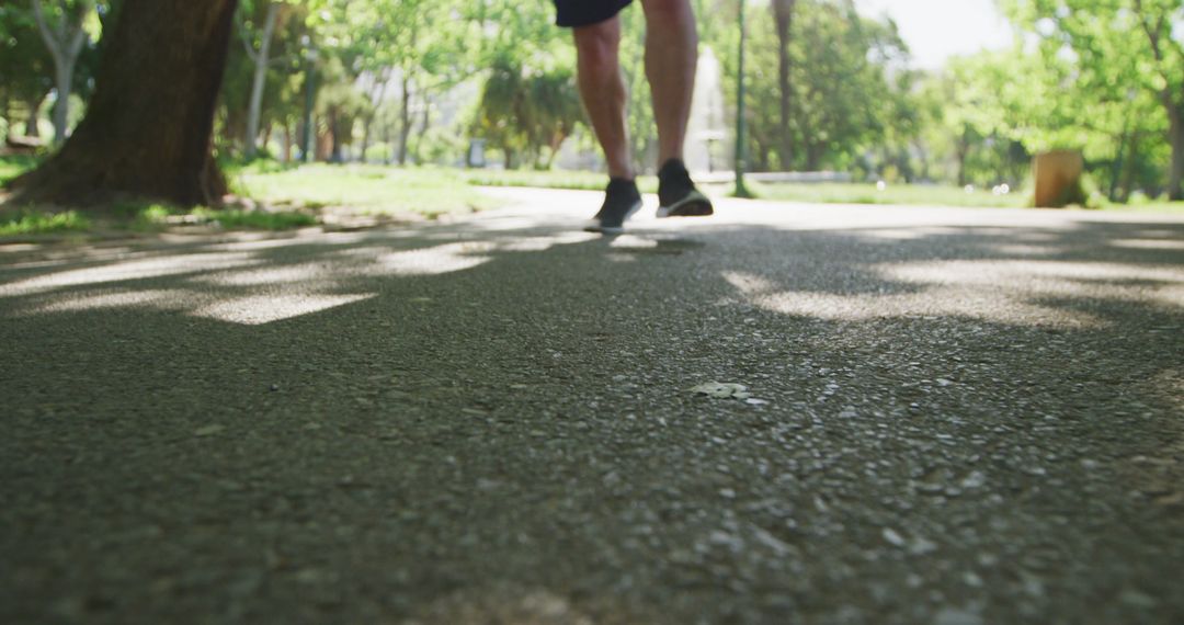 Close-up of Person Jogging in Sunny Park - Free Images, Stock Photos and Pictures on Pikwizard.com