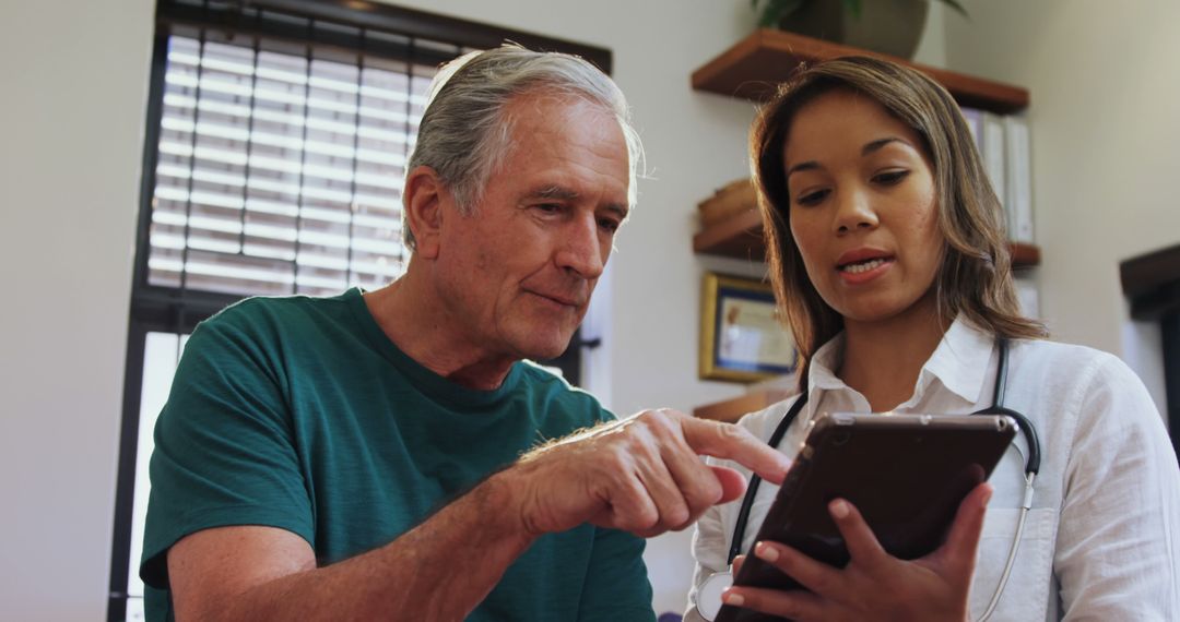 Senior man consulting with doctor using digital tablet - Free Images, Stock Photos and Pictures on Pikwizard.com