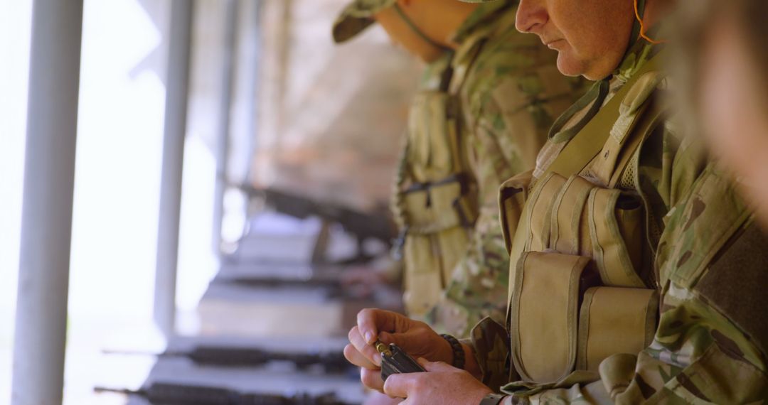 Caucasian Soldiers Loading Weapons in Training Exercise