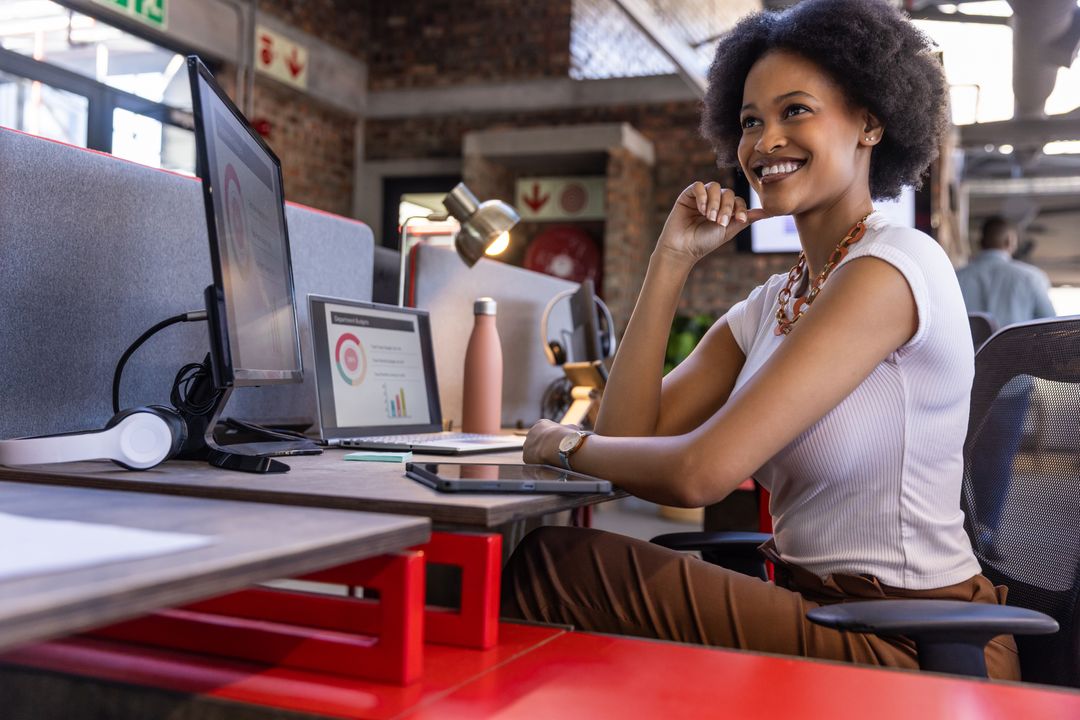 Confident Professional Woman Smiling at Modern Office Workspace