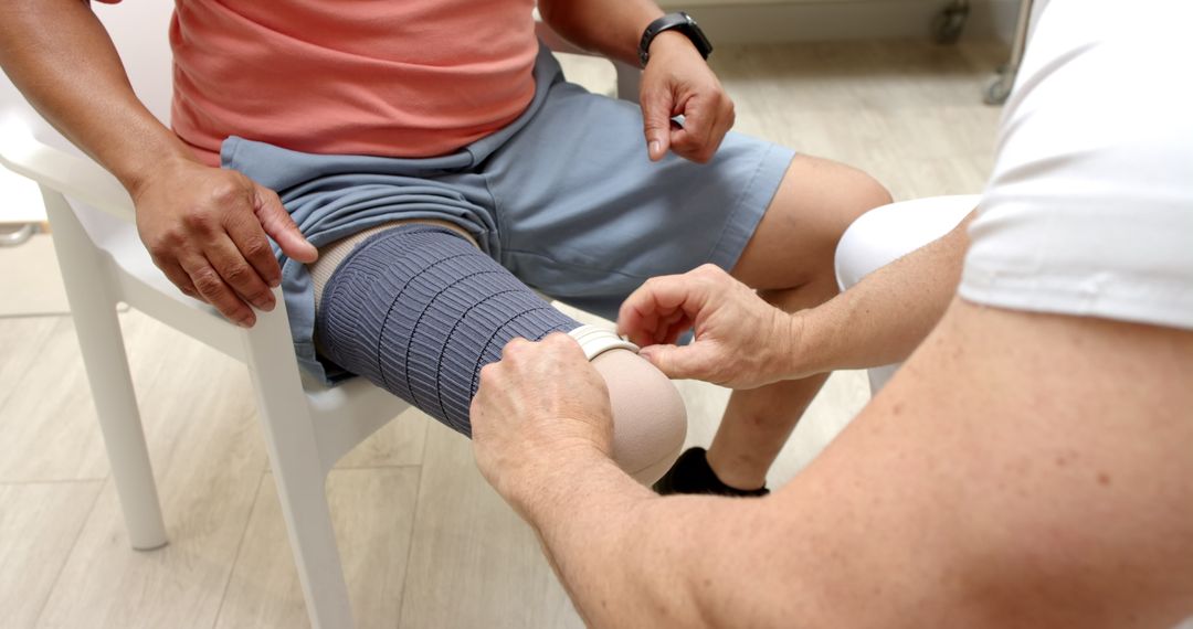 Expert Prosthetist Fitting Compression Sleeve for Elderly Patient