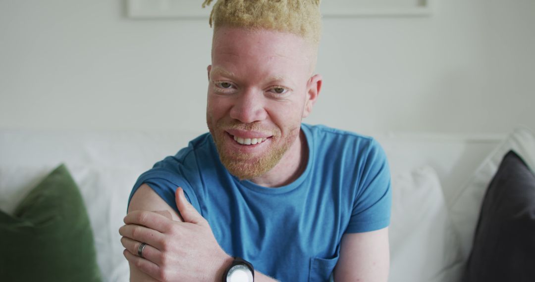 Portrait of Smiling Albino Man in Blue T-Shirt at Home - Free Images, Stock Photos and Pictures on Pikwizard.com