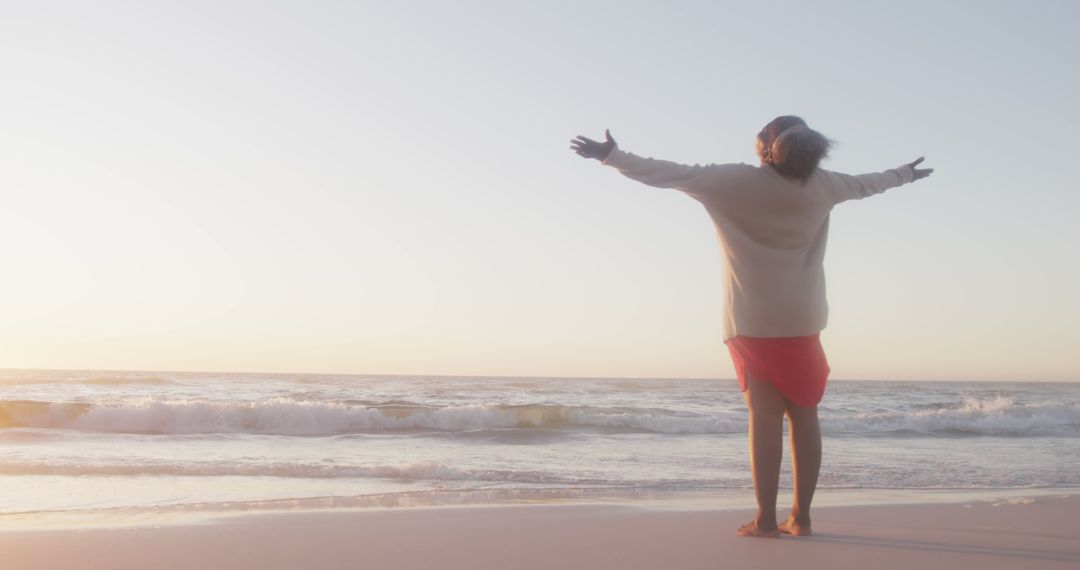 Woman Embracing Sunrise on Beach in Relaxation Pose - Free Images, Stock Photos and Pictures on Pikwizard.com