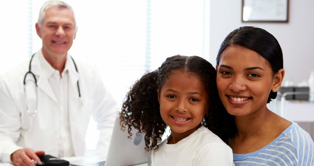 Smiling Mother and Daughter with a Doctor in Medical Office - Free Images, Stock Photos and Pictures on Pikwizard.com