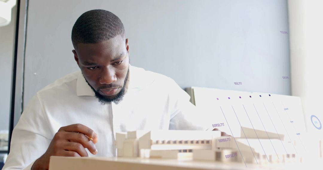 Focused Architect Analyzing Building Model at Workplace