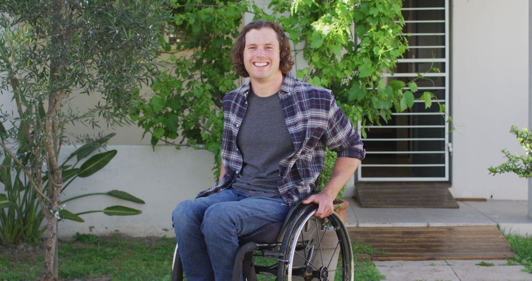 Smiling Young Man in Wheelchair Enjoying Outdoors at Home - Free Images, Stock Photos and Pictures on Pikwizard.com