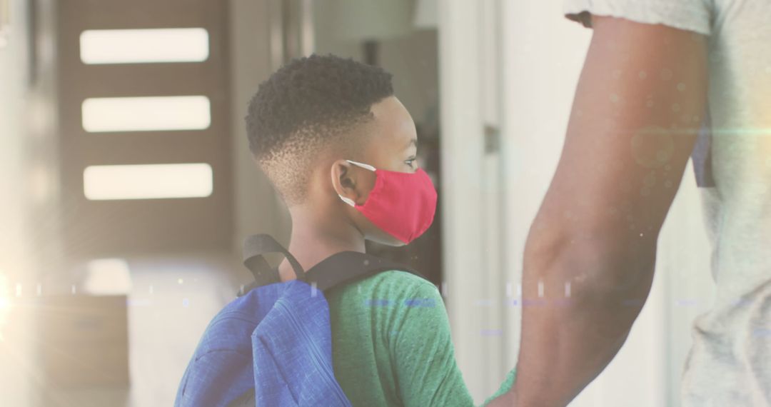 Young Boy Wearing Mask Holding Parent's Hand on Way to School