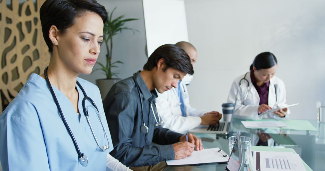 Medical Professionals Attending Meeting at Office Conference Table - Free Images, Stock Photos and Pictures on Pikwizard.com