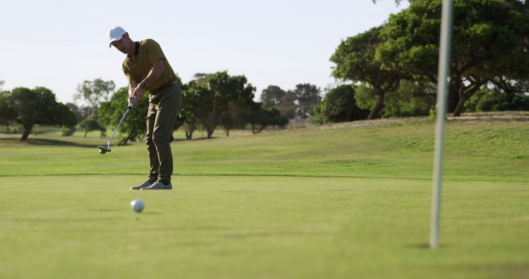 Man Putting in Golf Course on Sunny Day