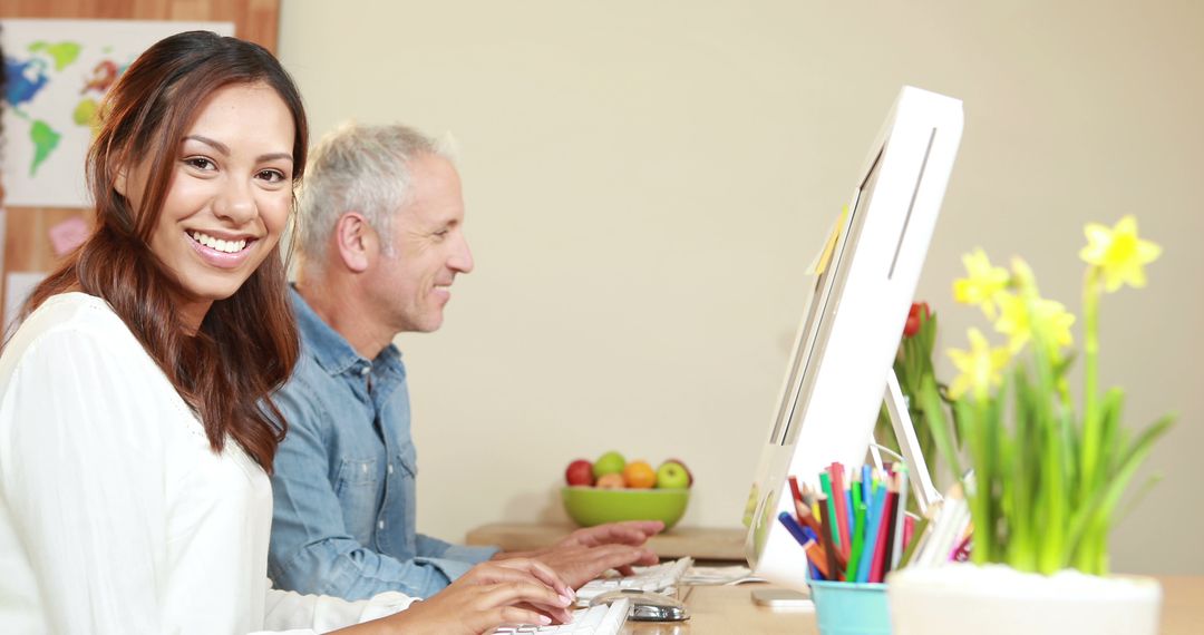 Diverse Team Smiling While Collaborating in Modern Workspace