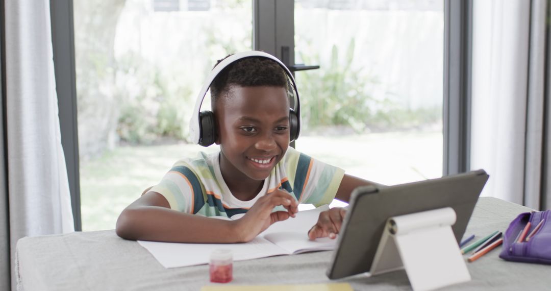 African American Boy Learning Online with Tablet at Home
