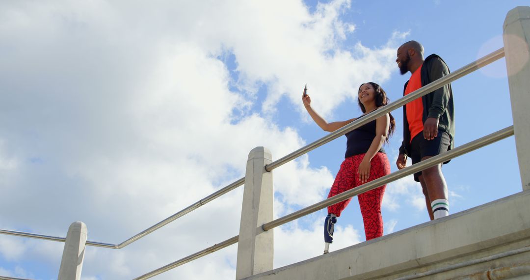 Two Friends with Prosthetic Legs Taking Selfie on Sunny Day - Free Images, Stock Photos and Pictures on Pikwizard.com