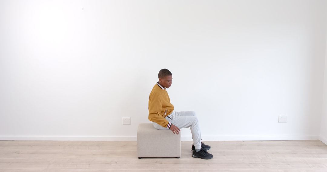 Man Relaxing on Ottomon in Minimalist Room Setting Midjourney