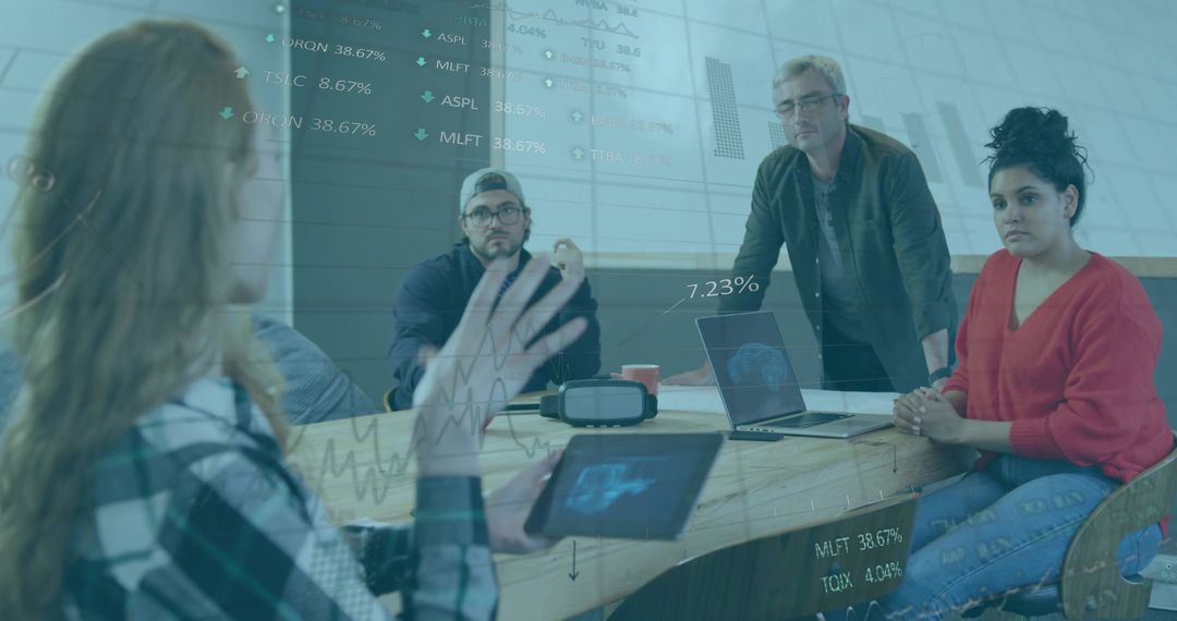 Collaborating Team Utilizing Technology in Modern Office Meeting