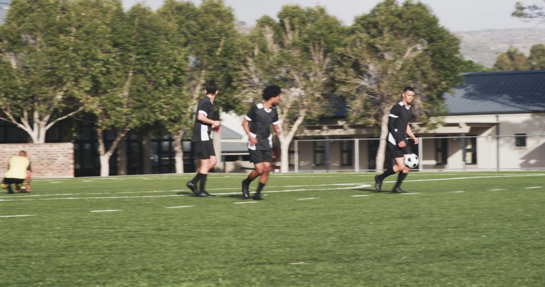 Teen Soccer Players Practicing Teamwork on Sunny Field