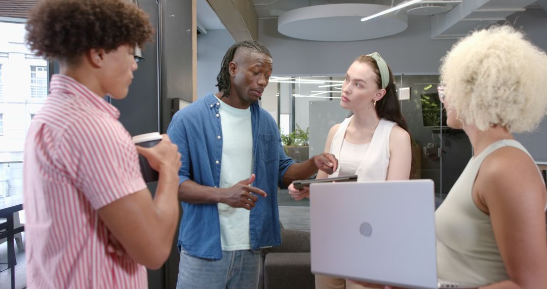 Diverse Team Collaborating with Technology and Coffee in Work Meeting
