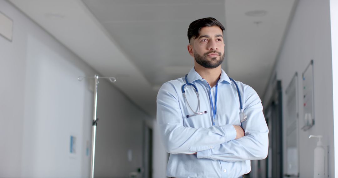 Confident Male Doctor Standing in Hospital Hallway with Stethoscope - Free Images, Stock Photos and Pictures on Pikwizard.com